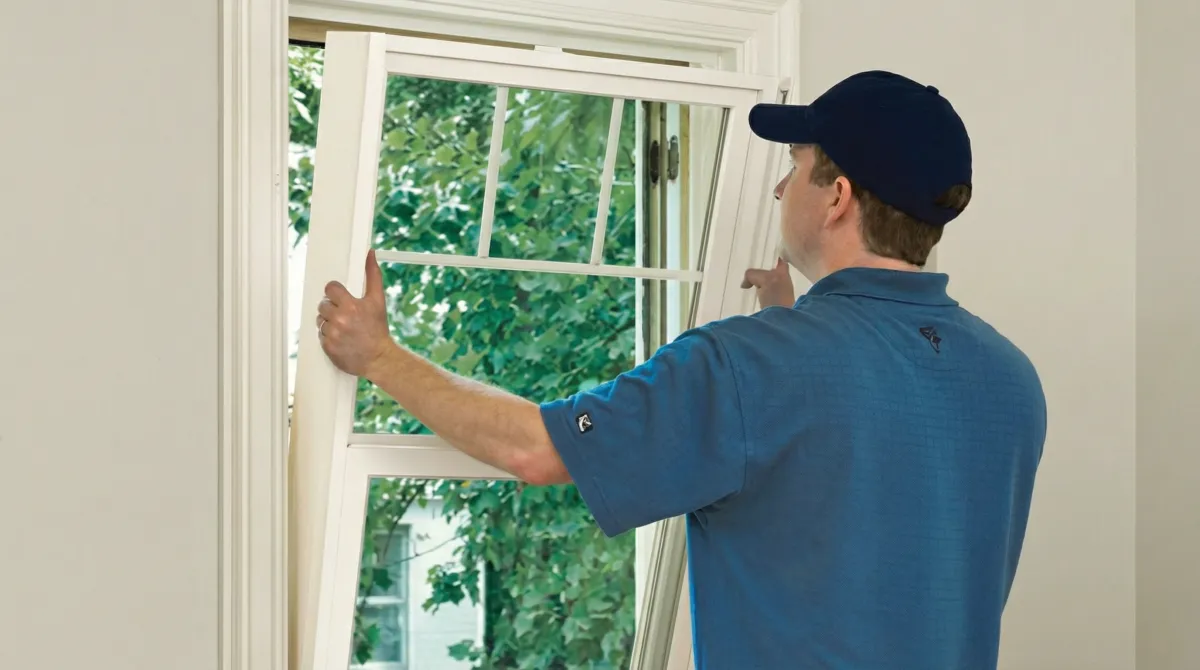 Professional contractors performing a residential window insulation and replacement service in Overland Park, KS